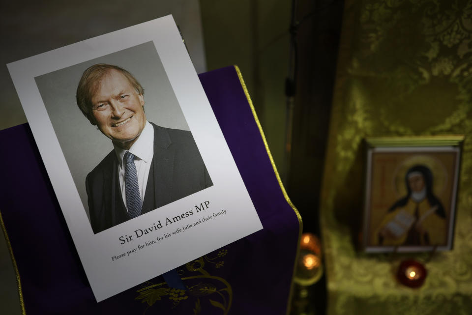 LEIGH-ON-SEA, ENGLAND - OCTOBER 15: A photograph of Sir David Amess is displayed during a vigil held at Saint Peter's Catholic Church, following the stabbing of UK Conservative MP Sir David Amess as he met with constituents at a constituency surgery on October 15, 2021 in Leigh-on-Sea, England. Sir David Amess, 69, Conservative MP for Southend West, has died from his injuries after being stabbed multiple times at his constituency surgery taking place in Belfair Methodist Church. A man was arrested at the scene. (Photo by Dan Kitwood/Getty Images)
