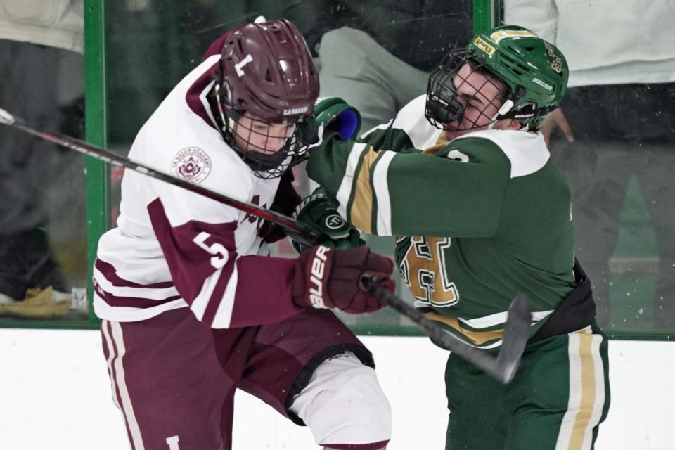 Hendricken's Griffin Crain, right, delivers a hit on La Salle's Devin Morra during the second period of Friday's game.