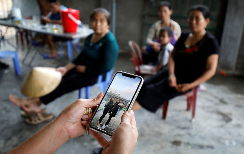 A relative shows a picture taken in Berlin of Anna Bui Thi Nhung, a Vietnamese suspected to be among dead victims found in a lorry in Britain, at her home in Nghe An province