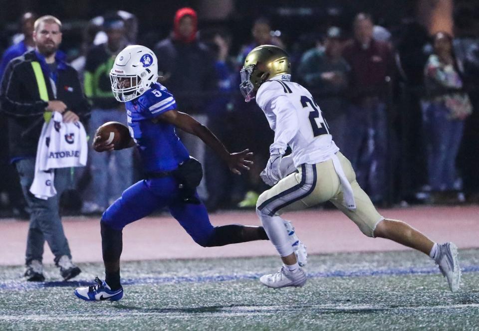 Dover's Nahseem Cosme (5) turns the corner on a long gain as Salesianum's Jacob Ziegler pursues him in the third quarter of the Senators' 27-16 win in Dover, Friday, Sept. 29, 2023.