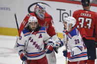 New York Rangers left wing Chris Kreider (20) celebrates his goal with center Mika Zibanejad (93) during the first period of an NHL hockey game against Washington Capitals goaltender Vitek Vanecek (41), Saturday, Feb. 20, 2021, in Washington. (AP Photo/Nick Wass)