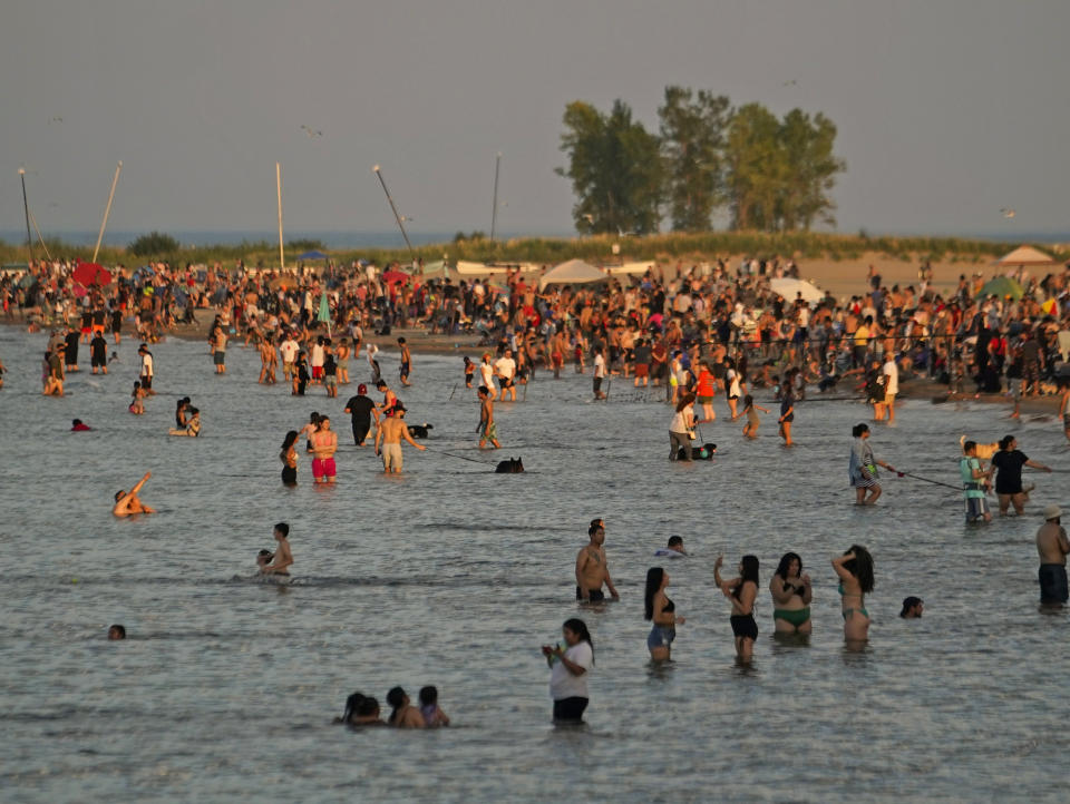 Beachgoers crowd Montrose Beach in the early evening Monday, Sept. 4, 2023, in Chicago.  (Kiichiro Sato / AP)