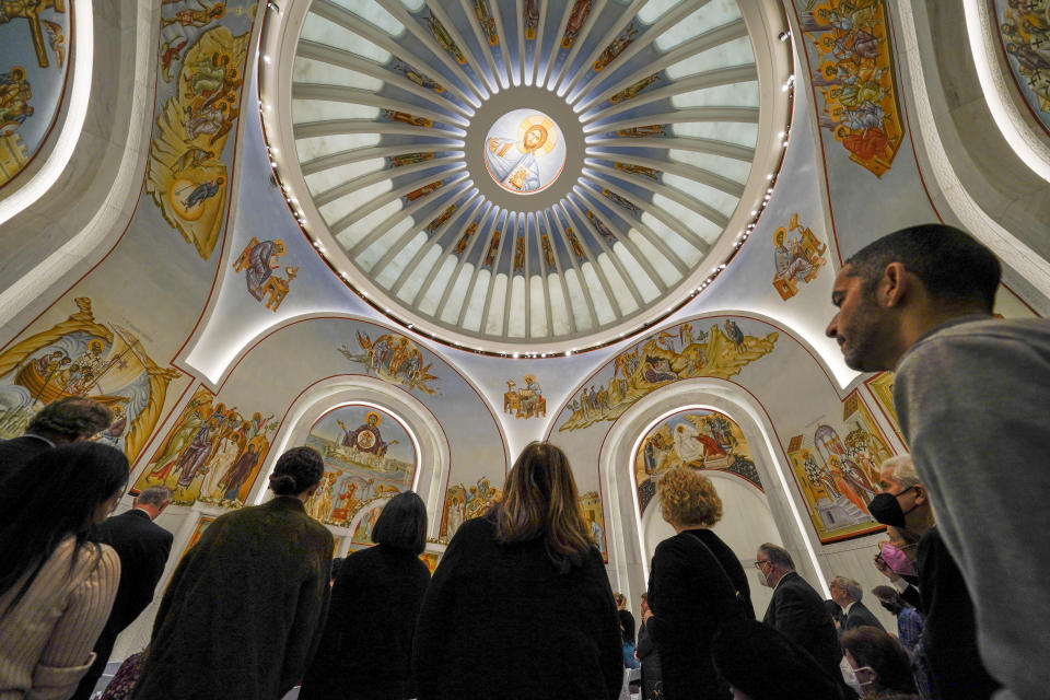 *People attend a service at St. Nicholas Greek Orthodox Church in New York, Tuesday, Dec. 6, 2022. After a rebuilding process that lasted more than two decades, the Greek Orthodox church that was destroyed in the Sept. 11 attacks has reopened at the World Trade Center site. The St. Nicholas Greek Orthodox Church and National Shrine, designed by architect Santiago Calatrava, now overlooks the Trade Center memorial pools from an elevated park. (AP Photo/Seth Wenig)