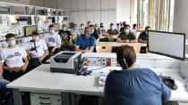 FILE - In this Thursday, Aug. 13, 2020 file photo, students of the Robert-Koch vocational college sit with face masks in the classroom during computer science lessons in Dortmund, Germany. Despite a spike in coronavirus infections, authorities in Europe are determined to send children back to school. At least 41 of Berlin’s 825 schools reported virus cases as classes resumed this month, and thousands of students have been quarantined around the country. But Germany is determined not to close schools anew, so they're sending individual students or classes into quarantine instead. (AP Photo/Martin Meissner, File)