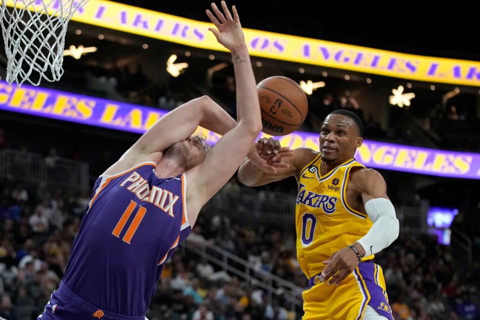 Los Angeles Lakers guard Russell Westbrook (0) fouls Phoenix Suns center Jock Landale (11) during the first half of a preseason NBA basketball game Wednesday, Oct. 5, 2022, in Las Vegas.