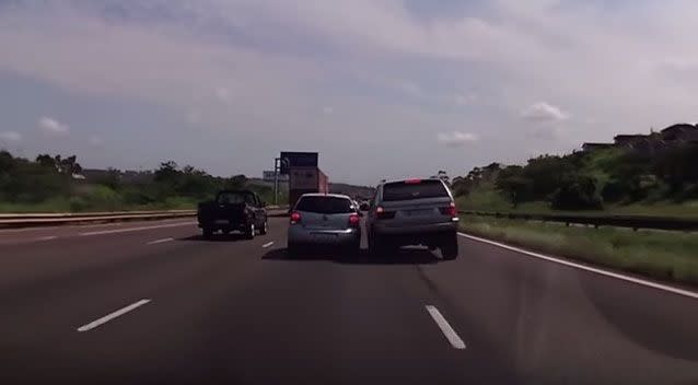 A BMW driver pushes another vehicle out of its lane on a high-speed highway. Picture: Ivan Leon