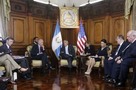 U.S. Vice-President Joe Biden (2nd L) and Guatemala's President Otto Perez Molina (C) talk during a meeting at the Presidential Palace in Guatemala City June 20, 2014. REUTERS/Pakal Koban