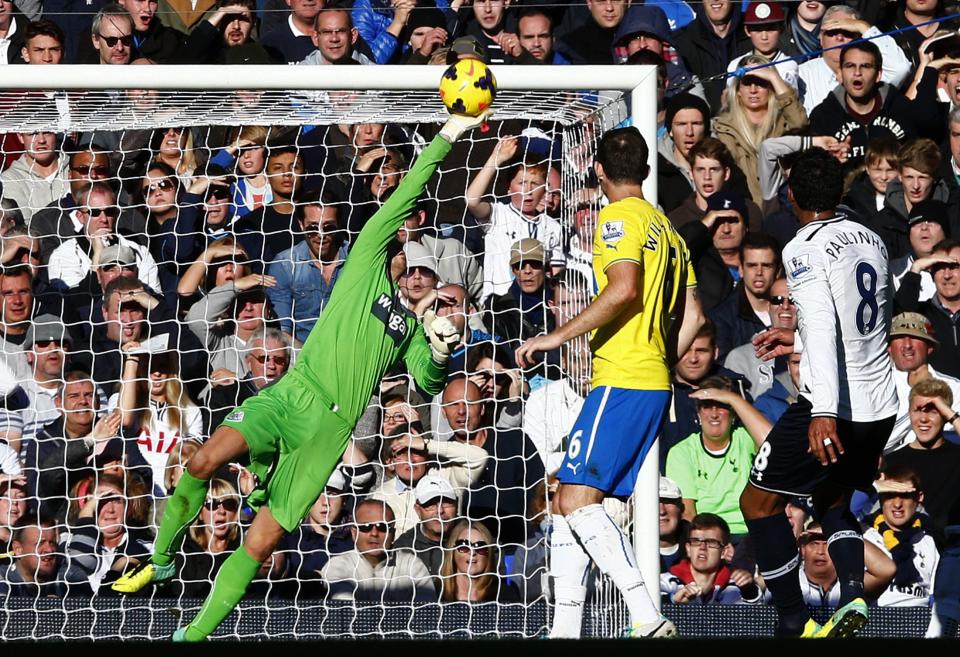 Newcastle United goalkeeper Tim Krul (L) makes a save from Tottenham Hotspur's Paulinho (R) during their English Premier League soccer match at White Hart Lane in London November 10, 2013.