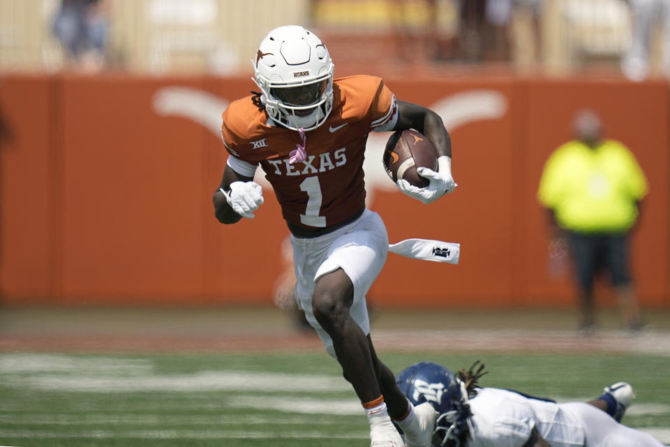 Texas wide receiver Xavier Worthy (1) past Rice cornerback Sean Fresch, right, after making a catch during the first half of an NCAA college football game in Austin, Texas, Saturday, Sept. 2, 2023. (AP Photo/Eric Gay)