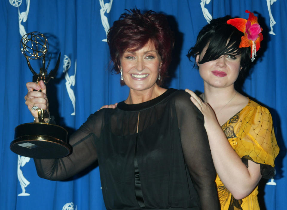 Sharon Osbourne, producer and wife of rock star Ozzy Osbourne (L) poses with the Emmy award she won for Outstanding Non-Fiction Program (Reality) for MTV's "The Osbournes", at the 2002 Primetime Creative Arts Emmy Awards, September 14, 2002 in Los Angeles, alongside her daughter Kelly. The reality television show features her husband, rock star Ozzy Osbourne, and their family. Sharon Osbourne recently underwent treatment for colon cancer. The Primetime Emmy awards will be presented September 22 in Los Angeles. REUTERS/Fred Prouser FSP/GN