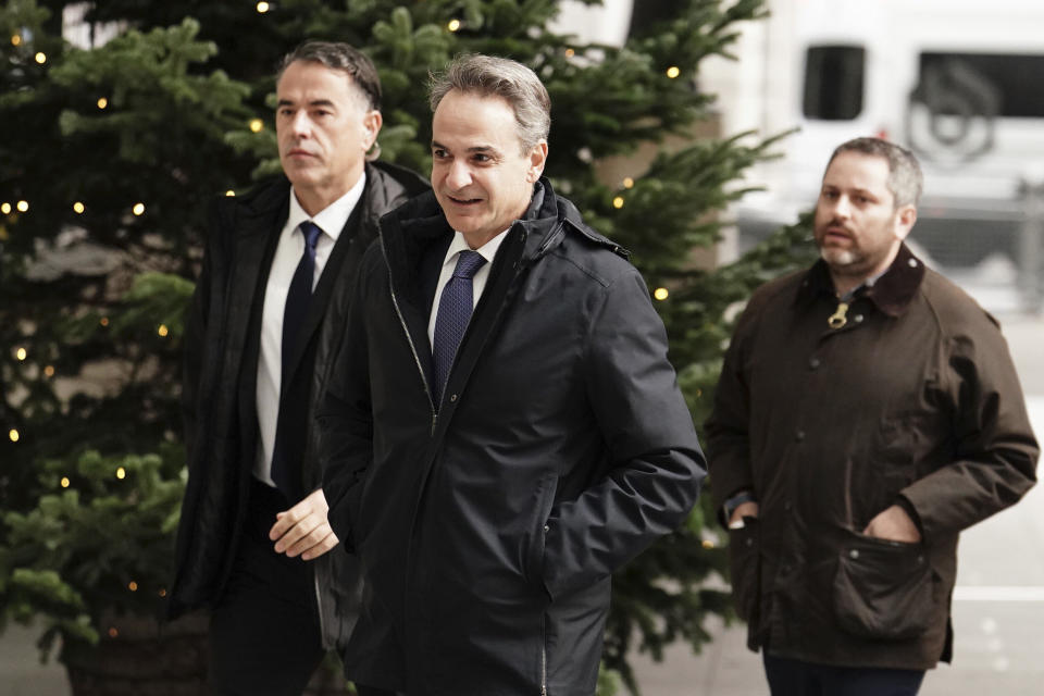 Prime Minister of Greece Kyriakos Mitsotakis, center, arrives at BBC Broadcasting House to appear on the BBC One current affairs programme, Sunday with Laura Kuenssberg, in London, Sunday, Nov. 26, 2023. (Jordan Pettitt/PA via AP)