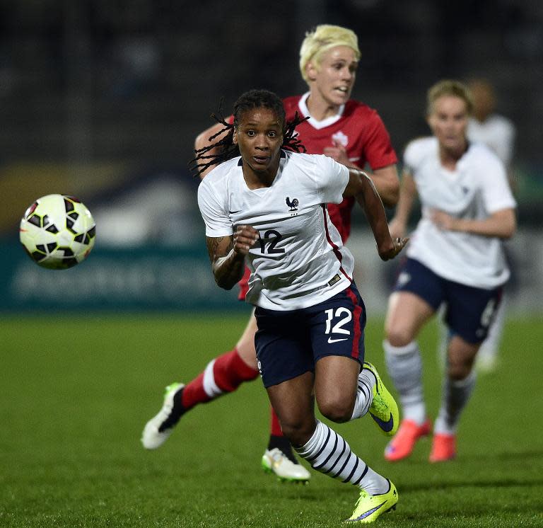 France's Elodie Thomis (C) chases the ball during their friendly match against Canada, at the Stade Robert-Bobin in Bondoufle, near Paris, on April 9, 2015