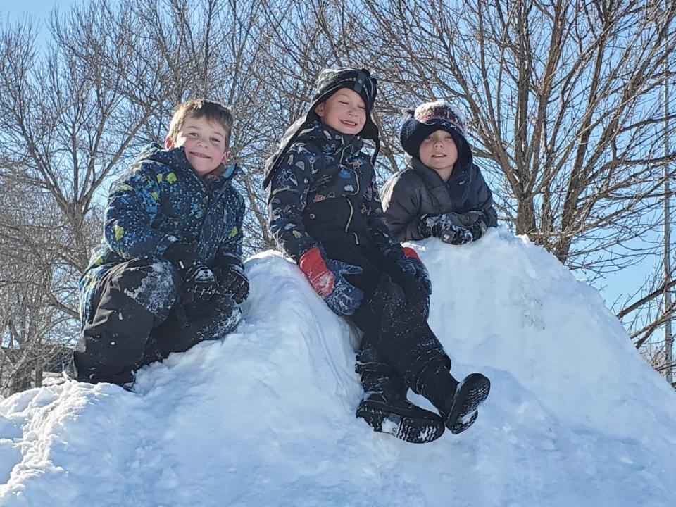 Tracker LaBarre, left, Harrison George and Ryan O'Connell are all kings of the hill at the playground near the South Mill Pond parking lot in Portsmouth Sunday, Jan. 30, 2022, a day after a blizzard hit the region.