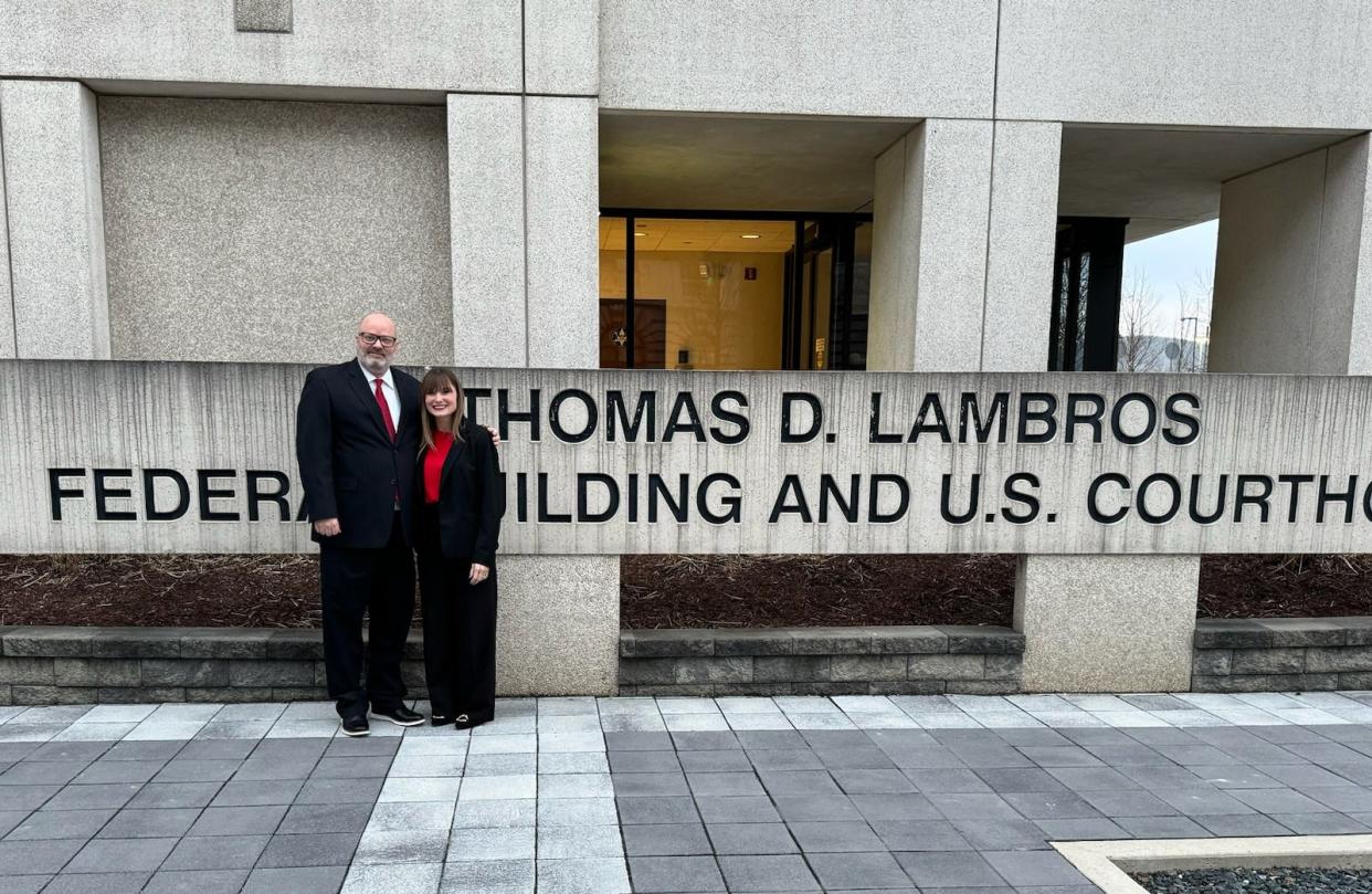 Norton Police officer Jason Sams and Ohio Patrolmen's Benevolent Association attorney Danielle Chaffin stand outside the Thomas D. Lambros Federal Building and United States Courthouse in Youngstown Feb. 1 after settling a civil lawsuit against the city of Norton.