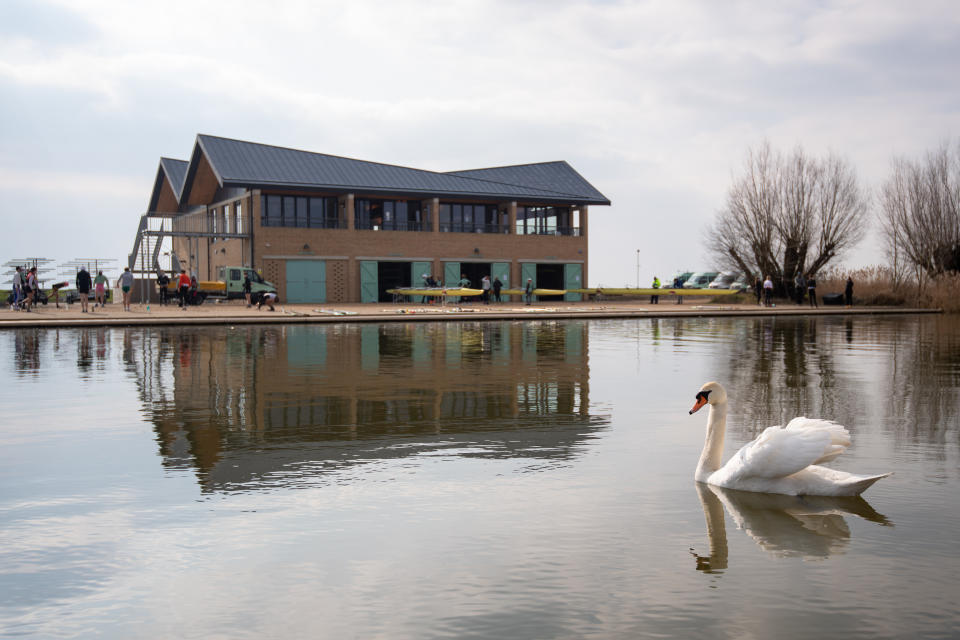 <p>A swan passes the Cambridge University Boat Club as crews train on the River Great Ouse near Ely in Cambridgeshire for the first time, as the Blue boats of Cambridge University Boat Club can return to training on the water from today under the strict Covid guidelines for elite sport agreed with the UK government.</p>
