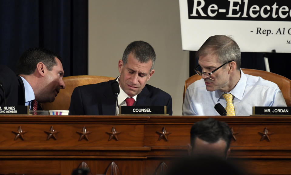 Ranking member Rep. Devin Nunes, R-Calif., talks to Rep. Jim Jordan, R-Ohio, right, as Steve Castor, Republican staff attorney for the House Oversight Committee, center listens during the House Intelligence Committee on Capitol Hill in Washington, Wednesday, Nov. 13, 2019, during the first public impeachment hearing of President Donald Trump's efforts to tie U.S. aid for Ukraine to investigations of his political opponents. (AP Photo/Susan Walsh)