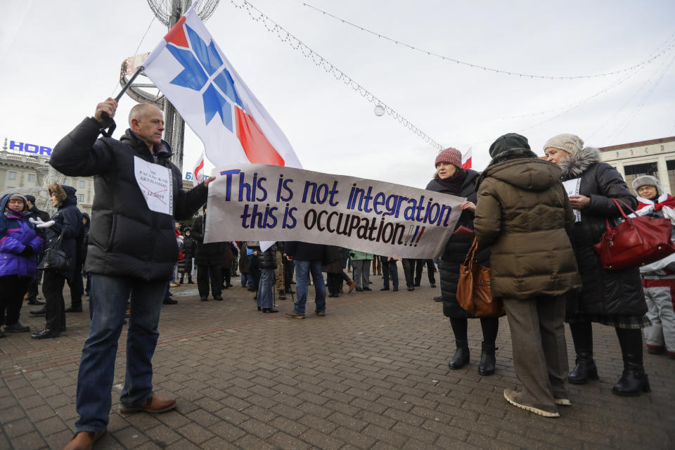 Protesters hold a banner during a rally in downtown Minsk, Belarus, Saturday, Dec. 7, 2019. Several hundreds demonstrators gathered to protest against closer integration with Russia. (AP Photo/Sergei Grits)