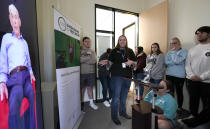 Amy Frake, center, explains to students, from Westchester Academy for International Studies, how to ask a question to Holocaust survivor William Morgan using an interactive virtual conversation exhibit at the the Holocaust Museum Houston Friday, Jan. 11, 2019, in Houston. The University of Southern California Shoah Foundation has recorded 18 interactive testimonies with Holocaust survivors over the last several years. (AP Photo/David J. Phillip)