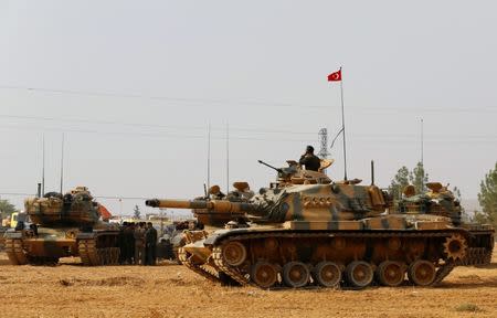 Turkish army tanks and military personal are stationed in Karkamis on the Turkish-Syrian border in the southeastern Gaziantep province, Turkey, August 25, 2016. REUTERS/Umit Bektas/File Photo