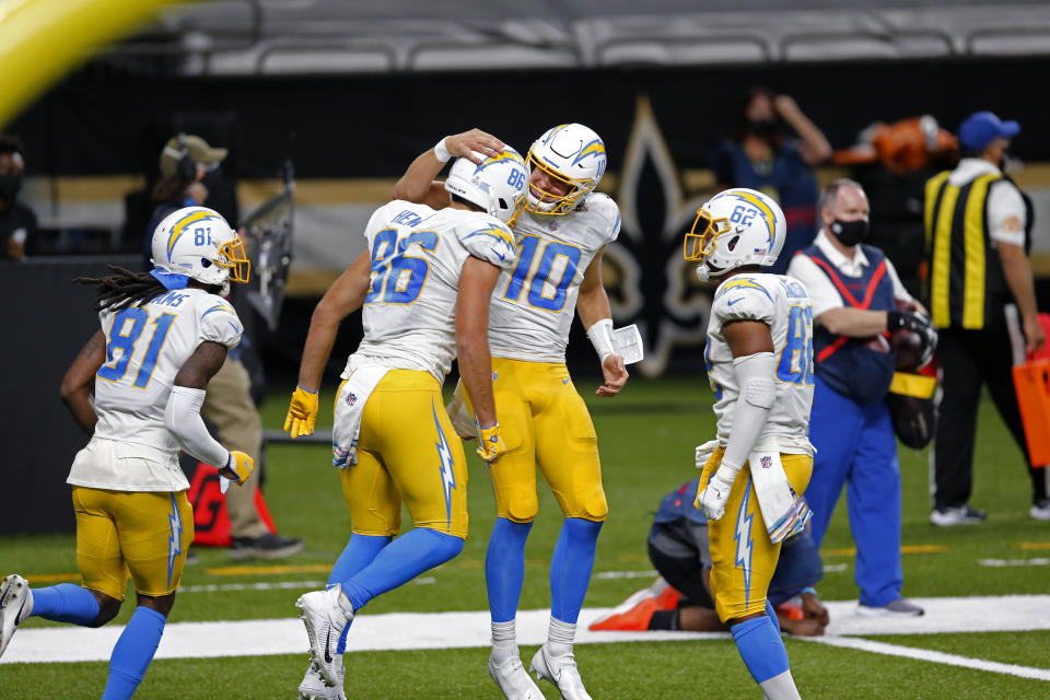 Los Angeles Chargers quarterback Justin Herbert (10) and tight end Hunter Henry (86) celebrate their touchdown pass in the first half of an NFL football game against the New Orleans Saints in New Orleans, Monday, Oct. 12, 2020. (AP Photo/Brett Duke)