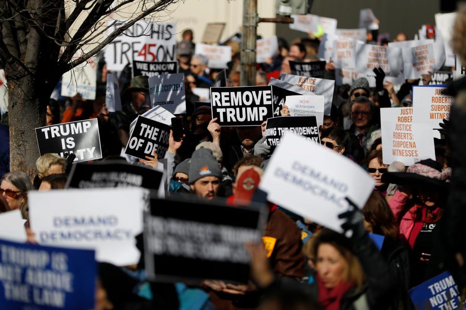 Demonstrators protest on their way to the Capitol during the Senate impeachment trial of President Donald Trump on Wednesday.