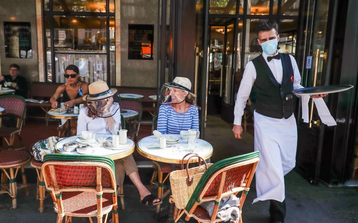 Customers wearing face shield hats in 'Cafe de Flore' in the Latin Quarter district as bars and restaurants reopen in Paris, France - CHRISTOPHE PETIT TESSON/EPA-EFE/Shutterstock/Shutterstock