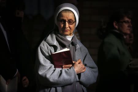 A nun and member of the Australian Ukrainian community reacts during a prayer vigil for those killed in the crash of Malaysia Airlines flight MH17, at the St Andrew's Ukrainian Catholic church in Sydney July 19, 2014. REUTERS/David Gray
