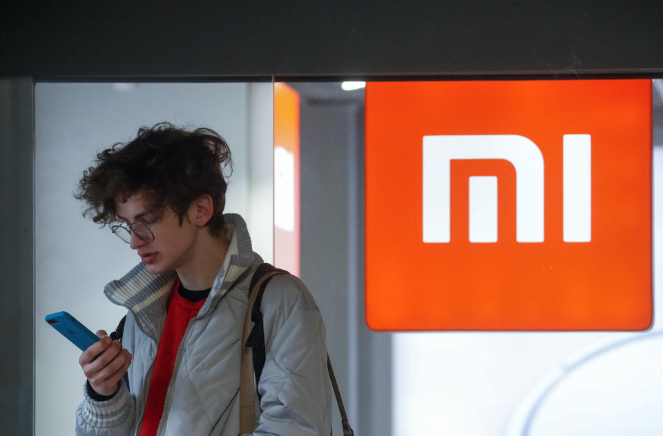 A man uses his smartphone next to the Xiaomi brand's store in central Kiev, Ukraine February 11, 2020.  REUTERS/Valentyn Ogirenko - RC2DYE9G9UVU