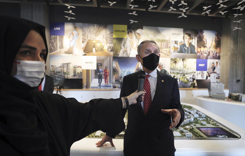 U.S. Ambassador John Rakolta talks with a UAE TV presenter during the U.S.A Pavilion handover ceremony at the Dubai Expo 2020, United Arab Emirates, Wednesday, Nov. 18, 2020. The U.S. showed off a literally star-studded pavilion Wednesday for Dubai's upcoming Expo 2020, complete with a replica SpaceX rocket body beside it. (AP Photo/Kamran Jebreili)