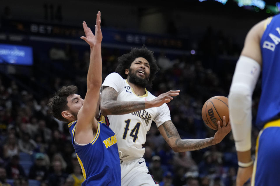 New Orleans Pelicans forward Brandon Ingram (14) tries to drives to the basket against Golden State Warriors guard Ty Jerome in the first half of an NBA basketball game in New Orleans, Monday, Nov. 21, 2022. (AP Photo/Gerald Herbert)