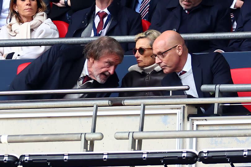 Sir David Brailsford leans across to speak to Sir Jim Ratcliffe at Wembley.