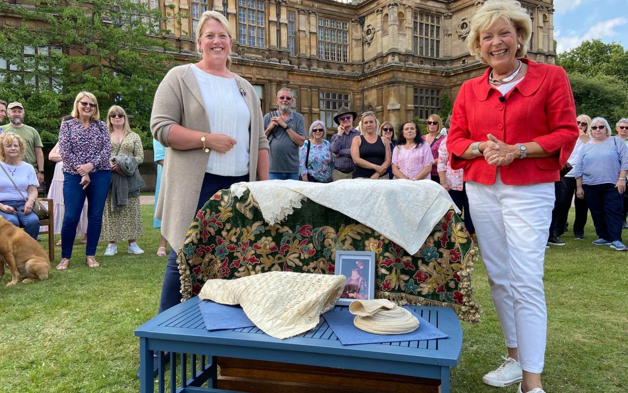 Antiques Roadshow's Hilary Kay (right) with the collection of Elizabethan textiles dating back 500 years at Wollaton Hall in Nottingham - BBC/PA