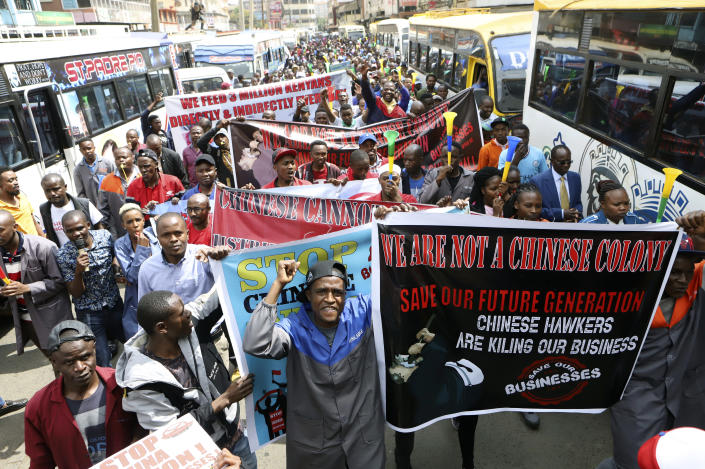 Small and medium business traders and other demonstrators carry banners as they protest asking the government to chase Chinese traders away, in Nairobi, Kenya, Tuesday, Feb. 28, 2023. The traders carried banners with Anti-Chinese messages and chanted 'Chinese must go', claiming Chinese businesspeople have flooded the city with counterfeit and cheap products, killing Kenyan businesses. (AP Photo)