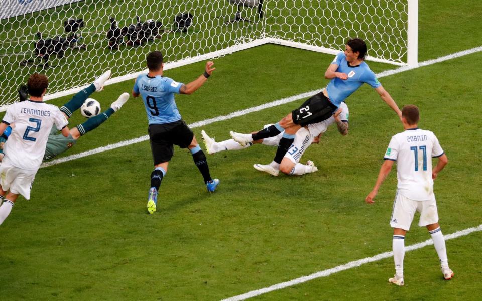 Edinson Cavani scores Uruguay's third from close range - REUTERS