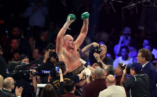 Tyson Fury, centre, is the WBC heavyweight champion (Bradley Collyer/PA)