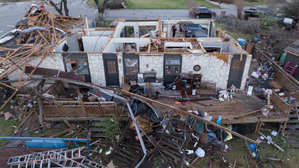 A woman walks through the garage of a destroyed home in the aftermath of a tornado in Round Rock on Tuesday (REUTERS)