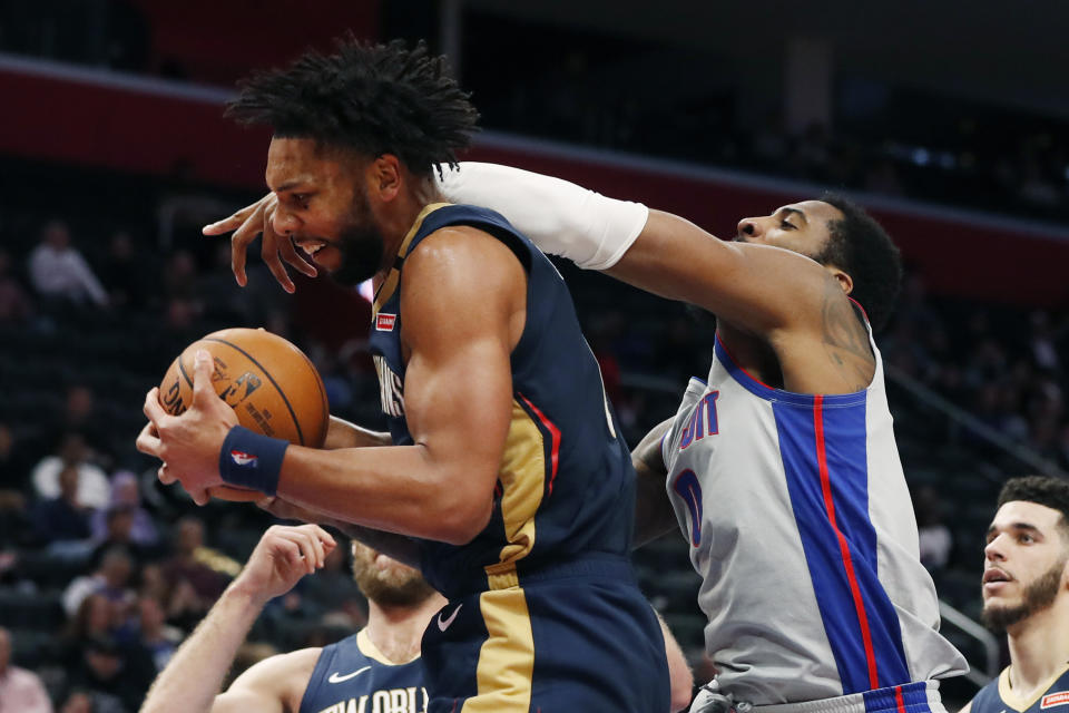 Detroit Pistons center Andre Drummond, right, reaches in as New Orleans Pelicans center Jahlil Okafor grabs a rebound during the first half of an NBA basketball game, Monday, Jan. 13, 2020, in Detroit. (AP Photo/Carlos Osorio)