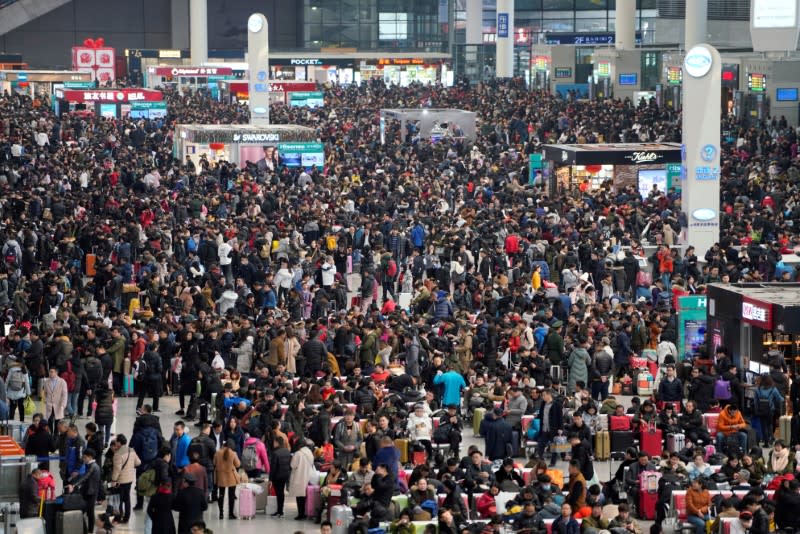 FILE PHOTO: File picture of passengers waiting to board trains at Shanghai's Hongqiao Railway Station as the annual Spring Festival travel rush begins ahead of the Chinese Lunar New Year in Shanghai