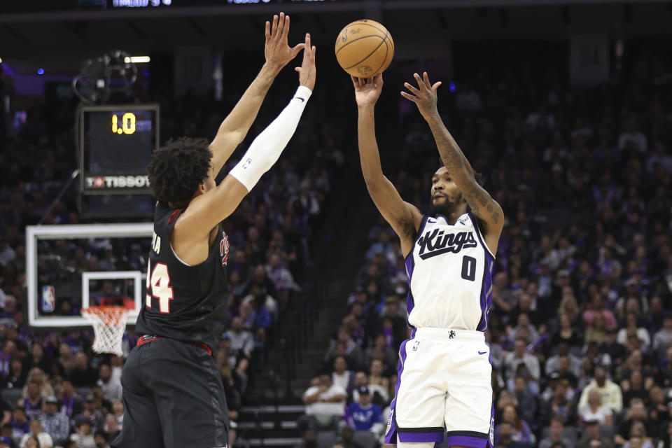 Sacramento Kings guard Malik Monk (0) shoots against Portland Trail Blazers forward Justin Minaya (24) during the second half of an NBA basketball game in Sacramento, Calif, Wednesday, Nov. 8, 2023. (AP Photo/Jed Jacobsohn)