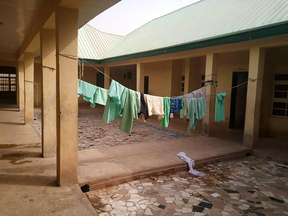 School uniforms displayed inside the deserted school dormitory, where over 300 schoolgirls were kidnapped by banditsAFP via Getty Images