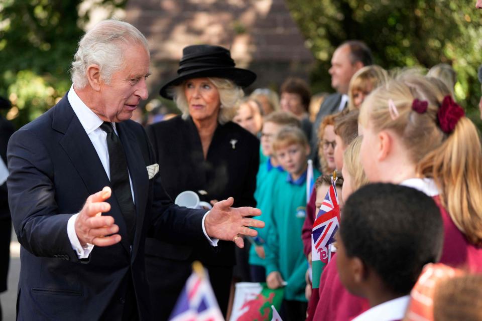 Britain's King Charles III (L) and Britain's Camilla (2nd L), Queen Consort, interact with member of the public after they attended a Service of Prayer and Reflection for the life of Queen Elizabeth II, at St Llandaff Cathedral in Cardiff on September 16, 2022.