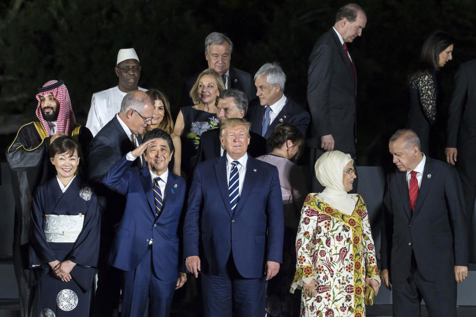 Japan's Prime Minister Shinzo Abe, second left front, gestures as U.S President Donald Trump, center, looks on during a family photo session in front of Osaka Castle at the G-20 summit (Tomohiro Ohsumi/Pool Photo via AP)