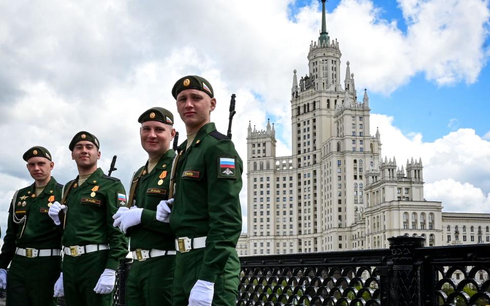 Russian servicemen pose after taking part in the Victory Day military parade in Moscow on May