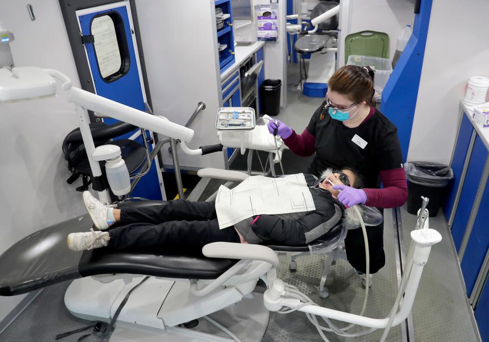 Hygenist Katie Wheeler cleans Sarahi Dominguez-Rodriguez ’s teeth during a Tri-County Dental mobile clinic, part of the  Robert Glass Focus on the Children program, on Tuesday, March 21, 2023 at Appleton Bilingual School in Appleton, Wis. Wm. Glasheen USA TODAY NETWORK-Wisconsin