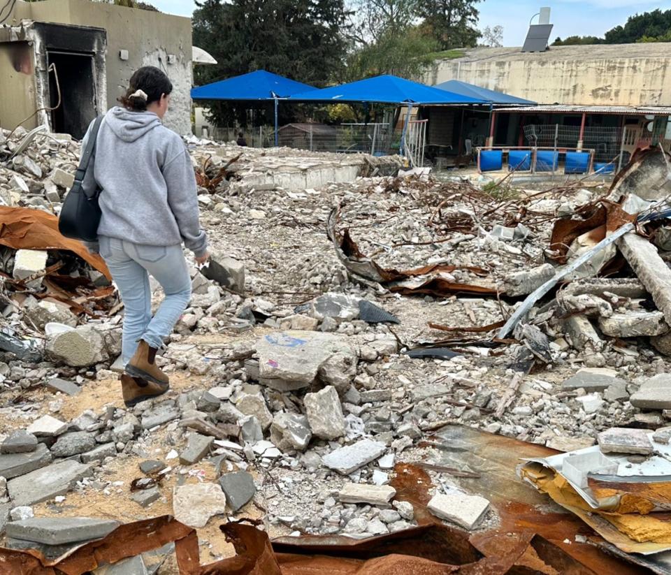 Nectar Shavit gives a tour of the destroyed recreation area at Kibbutz Be'eri. Her parents' house was also destroyed, but they survived.