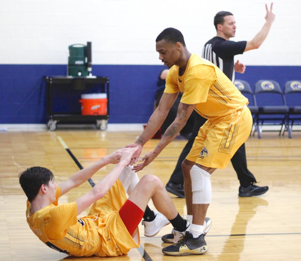 London Cobbs helps Kameron Shockley up after being fouled. He sank both free throws.