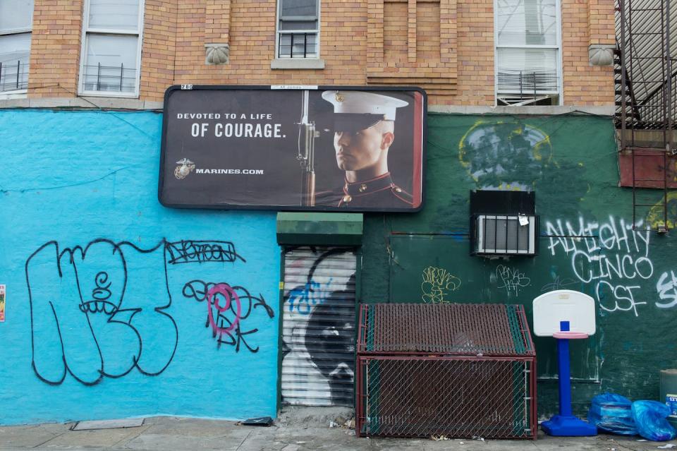 A marine recruiting poster in East New York. <a href="https://www.gettyimages.com/detail/news-photo/marine-recruiting-poster-in-one-of-new-york-citys-poorest-news-photo/539611890?adppopup=true" rel="nofollow noopener" target="_blank" data-ylk="slk:Andrew Lichtenstein/Corbis via Getty Images;elm:context_link;itc:0;sec:content-canvas" class="link ">Andrew Lichtenstein/Corbis via Getty Images</a>