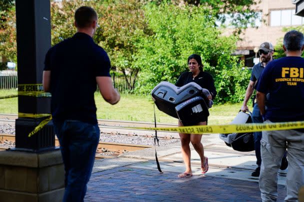 PHOTO: A woman cries while carrying a child's car seat, retrieved from the parade route, the day after a mass shooting at a Fourth of July parade in the Chicago suburb of Highland Park, Ill., July 5, 2022. (Cheney Orr/Reuters)