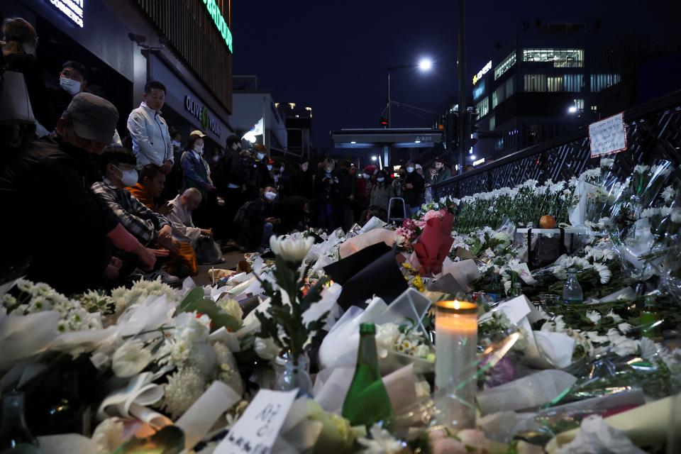 People pay their respects near the scene of the Halloween stampede (REUTERS)