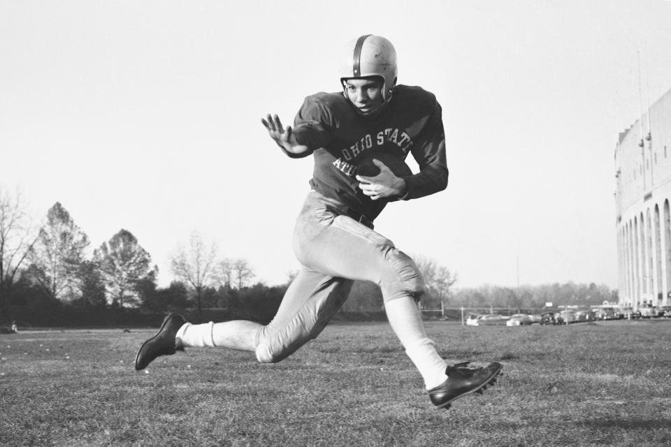 FILE - This 1953 file photo, shows Ohio State halfback Howard "Hopalong" Cassady in action pose in Columbus, Ohio. Cassady, a Heisman Trophy winner and former NFL running back, died early Friday, Sept. 20, 2019, in Tampa, Fla., Jerry Emig, the Ohio State associate athletic director said. He was 85. Cassady played both football and baseball at Ohio State in the early 1950s, winning the Heisman Trophy in 1955. He also played 10 seasons in the NFL, mostly with the Detroit, and got the nickname "Hopalong" from local sports writers after the black-hatted Western star of the 1950s. (AP Photo/Harold Valentine, File)